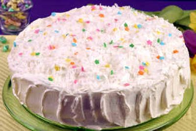 
Coconut Almond Cake is frosted and decorated with a springlike scattering of tiny candy flowers. Shredded coconut and almond paste give the dessert a rich texture and taste. 
 (Associated Press / The Spokesman-Review)