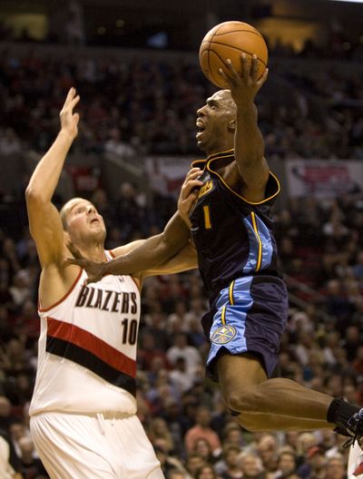 Denver Nuggets guard Chauncey Billups, right, goes to the hoop against Portland Trail Blazers center Joel Przybilla.  (Associated Press / The Spokesman-Review)