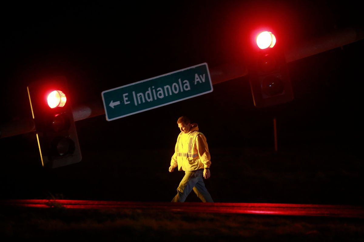 A utility worker tends to a downed stoplight on U.S. Highway 69 on Saturday in Des Moines, Iowa, after a strong storm caused damage in areas of central Iowa. (Bryon Houlgrave)
