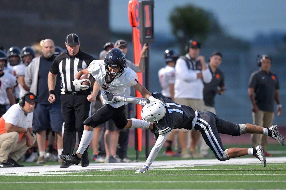 Lewis and Clark’s Gentz Hillburn runs the ball against Ridgeline during Friday’s season-opening game at Ridgeline High School in Liberty Lake. The Falcons, playing their first game, fell to LC 33-13.  (Tyler Tjomsland/The Spokesman-Review)