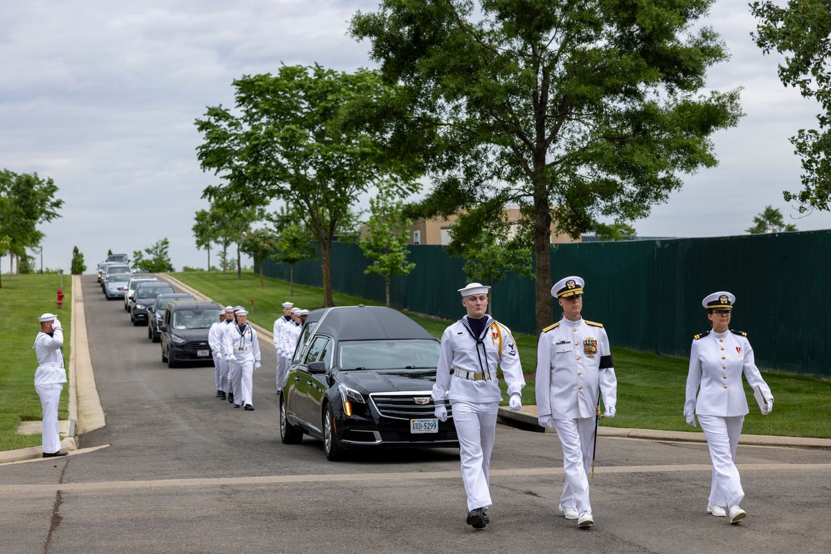The U.S. Navy Ceremonial Guard, with the hearse carrying Navy Radioman 3rd Class Starring Brooks Winfield, marches down McClellan Road in Arlington National Cemetery on May 9. (MUST CREDIT: Robb Hill for The Washington Post)  (Robb Hill/for The Washington Post)