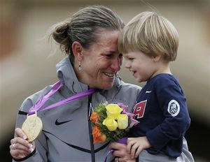 Gold medalist Kristin Armstrong, of the United States, celebrates with her son, Lucas, after the women's individual time trial event at the 2012 Summer Olympics, Wednesday, Aug. 1, 2012, in London. (AP / Matt Rourke)