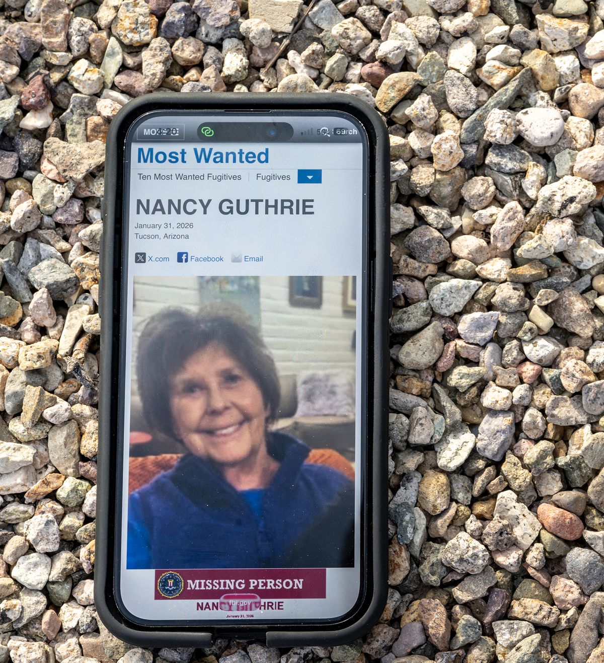 In this photo illustration, Nancy Guthrie is seen on the FBI website on a cellular phone Feb. 10, 2026, in Tucson, Arizona. Searches continues for Nancy Guthrie, the 84-year-old mother of U.S. journalist and television host Savannah Guthrie, after she went missing from her home on the morning of February 1st. (Brandon Bell/Getty Images North America/TNS)