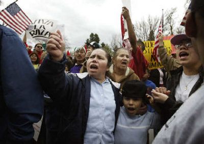 
Maria Hurtado, center, and her son Daniel shout during a protest in Yakima on Sunday against a U.S. House-approved immigration bill. 
 (KRIS HOLLAND Yakima Herald-Republic / The Spokesman-Review)