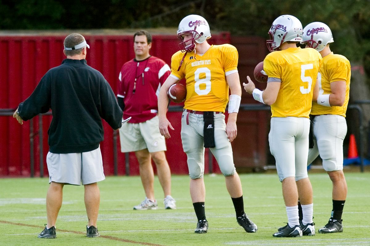 Lobbestael, center, listens to WSU offensive coordinator Todd Sturdy, left, as head coach Paul Wulff oversees. (Geoff Crimmins / The Spokesman-Review)