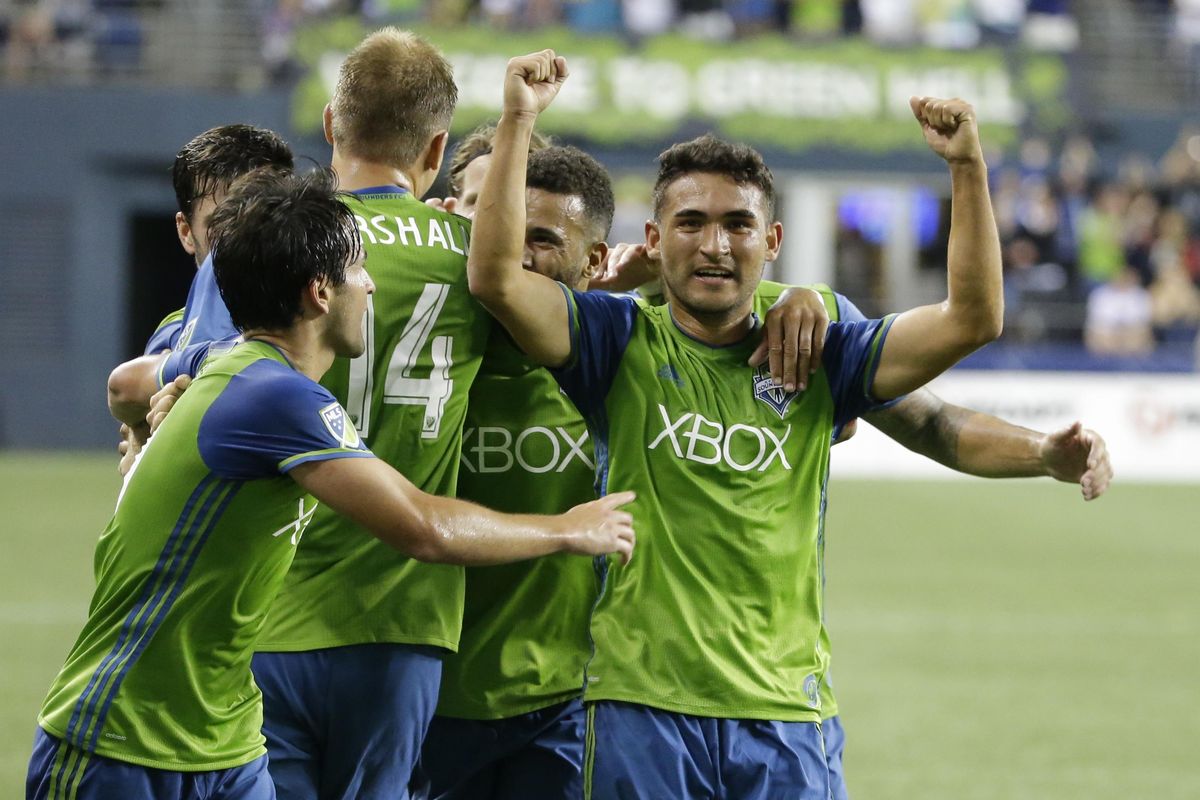 Seattle Sounders’ Cristian Roldan, right, celebrates with teammates after he scored a goal against the Portland Timbers during an MLS soccer match, Sunday, Aug. 21, 2016, in Seattle. (Ted S. Warren / Associated Press)