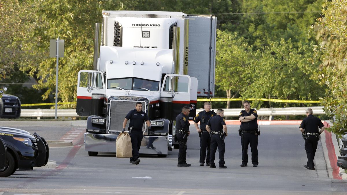 San Antonio police officers investigate the scene Sunday, July 23, 2017, where eight people were found dead in a tractor-trailer loaded with at least 30 others outside a Walmart store in stifling summer heat in what police are calling a horrific human trafficking case, in San Antonio. (Eric Gay / AP)