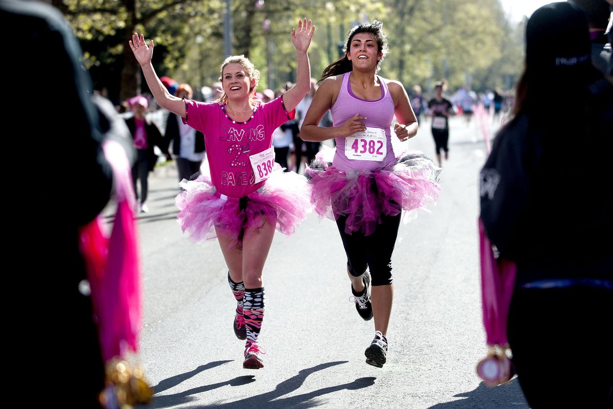 Gonzaga students Amber Hambrecht, left, and Yesenia Barajas finish the Susan G. Komen Race for the Cure together in Spokane on Sunday. (Kathy Plonka)