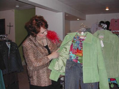
In her basement studio in Liberty Lake A.S.K. Clothing owner Tami Smith puts together a casual yet dressy ensemble with a green suede jacket that has become a popular item. 
 (Melodie Little / The Spokesman-Review)
