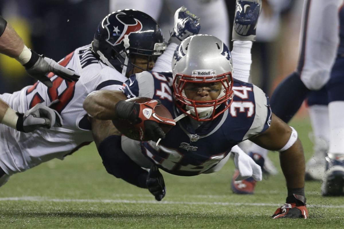 New England Patriots running back Shane Vereen dives for yardage while being tackled by Houston Texans strong safety Glover Quin. (Associated Press)