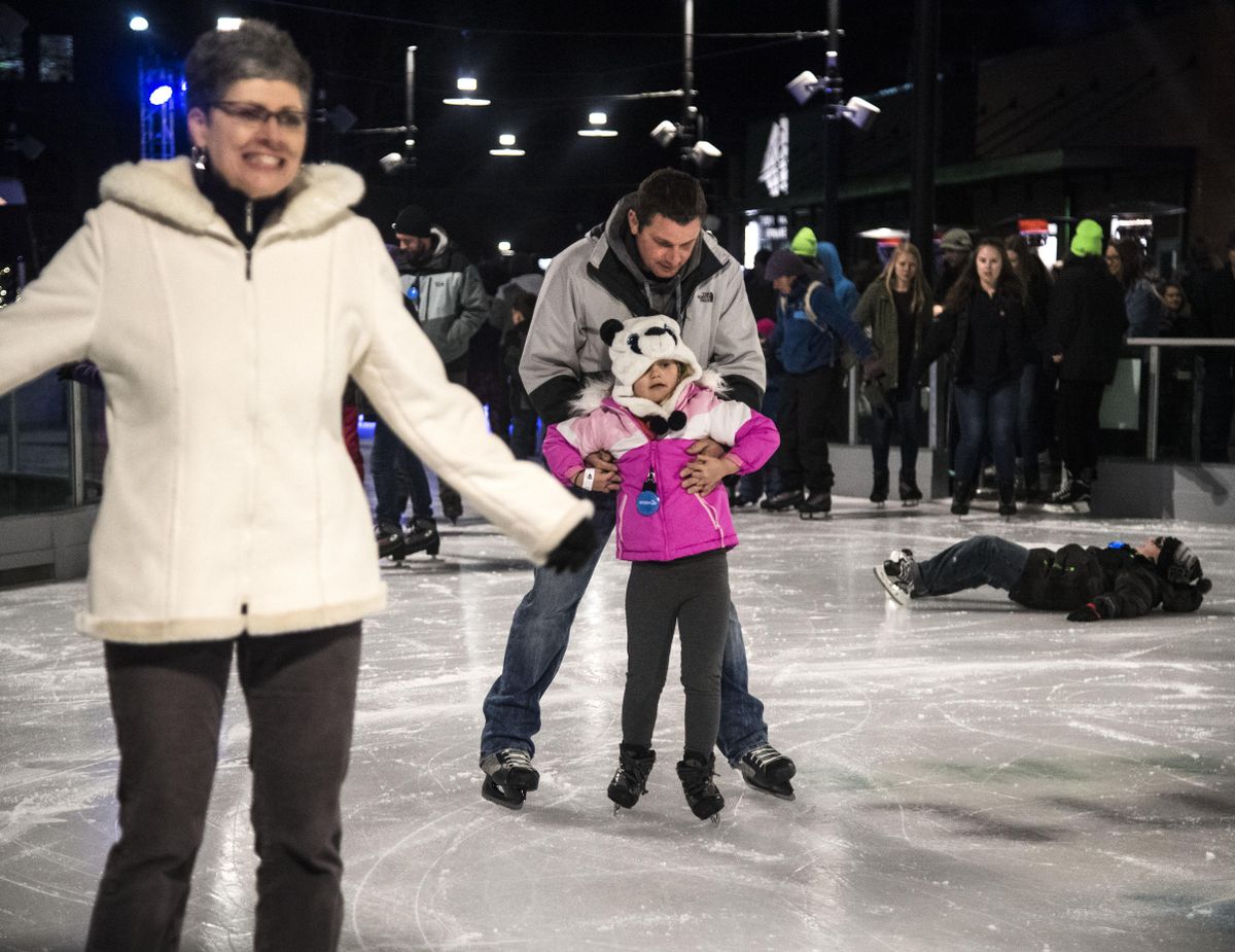 Chris Allison helps guide his daughter, Kendal, 7, around the ice during the grand opening of the Riverfront Park Skating Ribbon, Friday, Dec. 8, 2017, in downtown Spokane, Wash. (Dan Pelle / The Spokesman-Review)