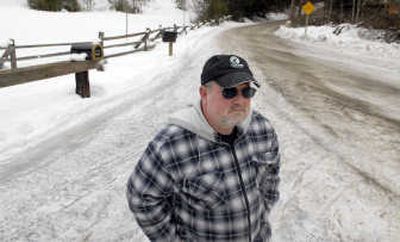 
Homer Davis stands near the designated mailbox area at the bottom of Triangle 7 Road in Hayden Lake last week. He is just one of several Hayden Lake residents living on Triangle 7 Road who is upset because the postmaster cut off mail delivery to their houses in November saying that the road is unsafe. 
 (Kathy Plonka / The Spokesman-Review)