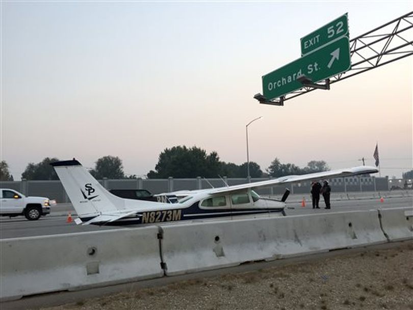 A small plane makes an emergency landing on I-84 in Boise, Idaho Tuesday, Oct. 13, 2015. Two law enforcement agencies say the small craft touched down about 7 a.m. on the eastbound lanes. (AP / Rebecca Boone)