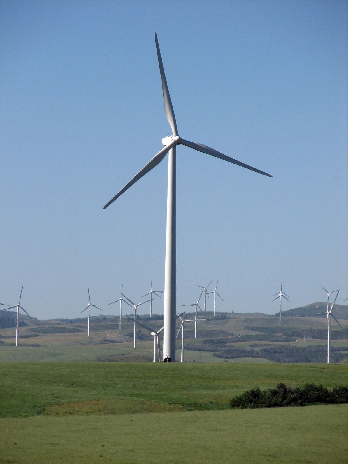 A 45-turbine wind farm in the hills above Idaho Falls is shown July 11. This wind farm would connect to a proposed 150-turbine project along the ridgeline to the west, pictured at left, in an area of Idaho’s Blackfoot Mountains known as Wolverine Canyon. Associated Press photos (Associated Press photos / The Spokesman-Review)