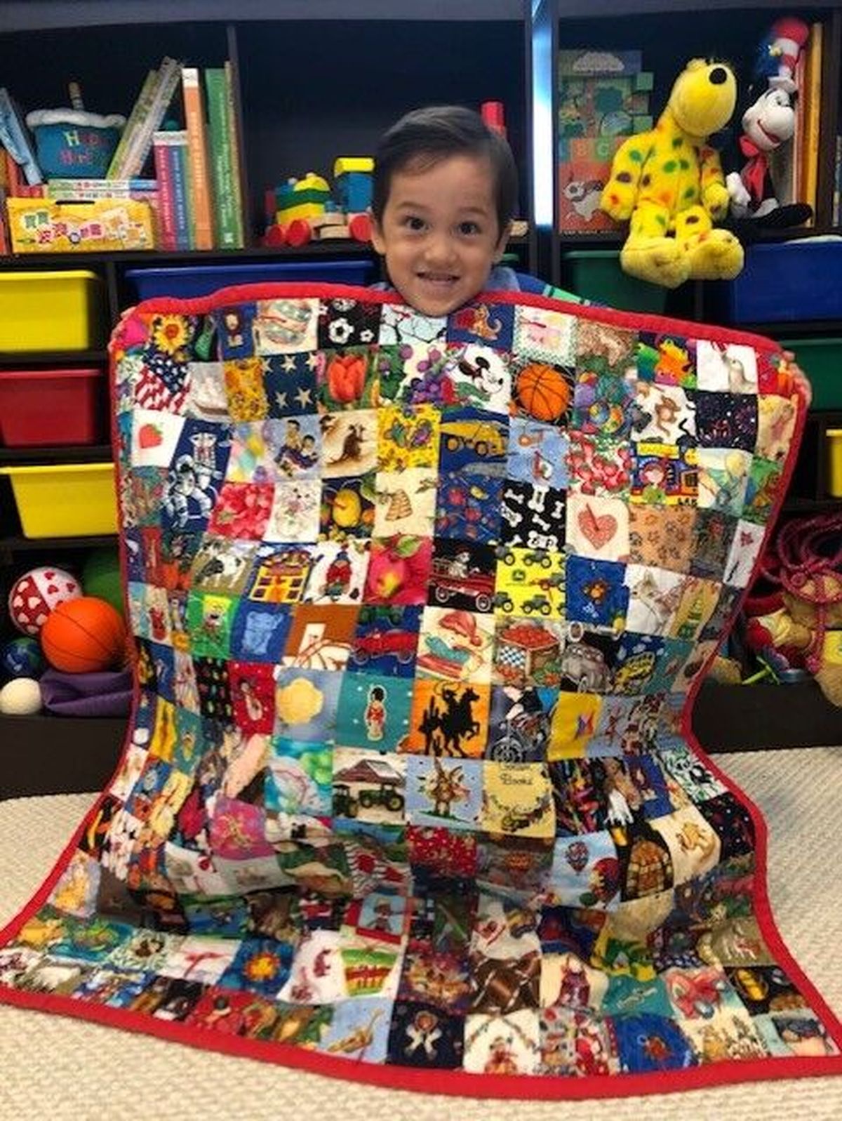 Lolita Sutton’s grandson Caleb holds up the quilt she made for him.  (Courtesy photo)