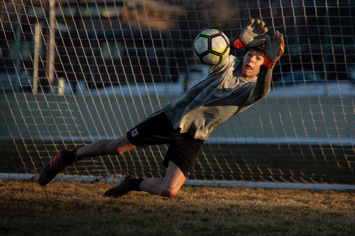 Sophomore goalkeeper Lucas Goeller makes a save on a penalty kick during a late-afternoon training session across from Lewis and Clark High  on Wednesday. (Libby Kamrowski / The Spokesman-Review)