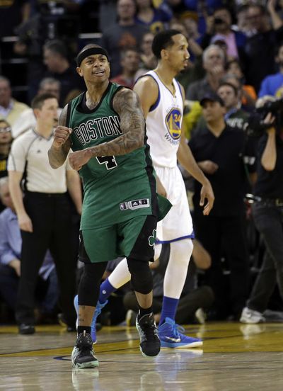 Boston Celtics' Isaiah Thomas (4) celebrates as time expires as Golden State Warriors' Shaun Livingston (34) walks off the court. (Marcio Jose Sanchez / Associated Press)
