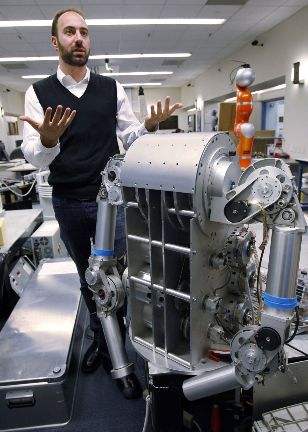 Associated Press photos Ryan Calo, a fellow of Stanford Center for Internet and Society, is shown Nov. 24 next to a robot that is being built for medical applications at Stanford University’s Artificial Intelligence Laboratory in Palo Alto, Calif. (Associated Press photos)
