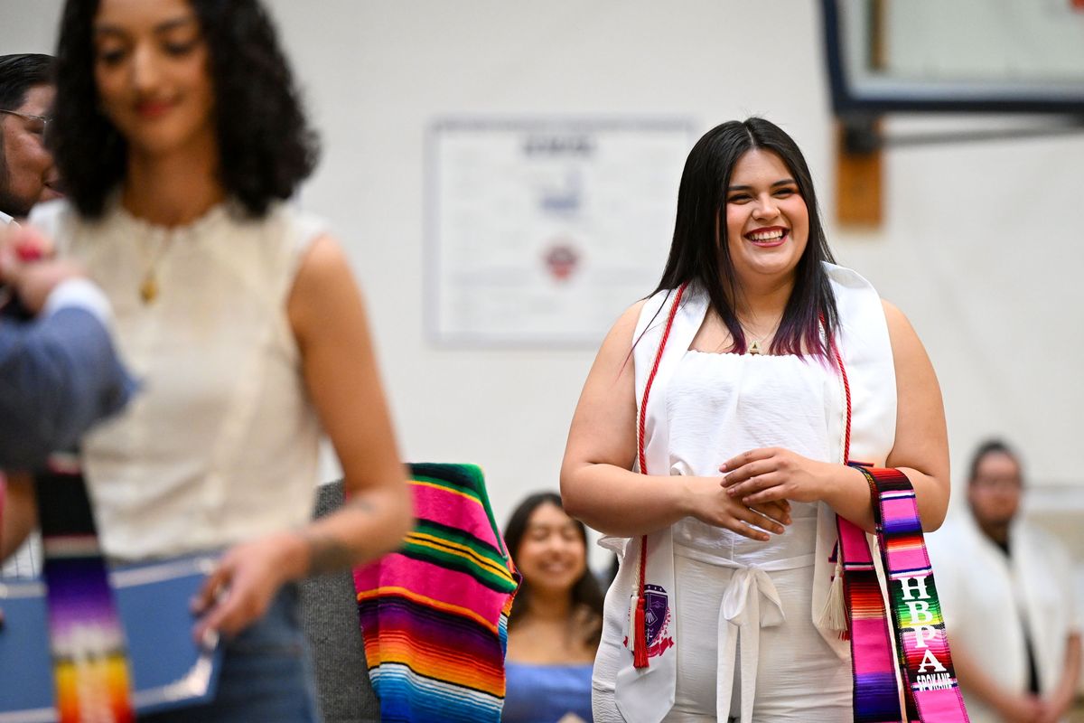 Eastern Washington University student Alejandra Guzman-Mercado walks the stage at the 30th annual Hispanic/Latino Graduation Ceremony on May 8 at Spokane Community College. (DAN PELLE/FOR THE SPOKESMN-REVIEW)