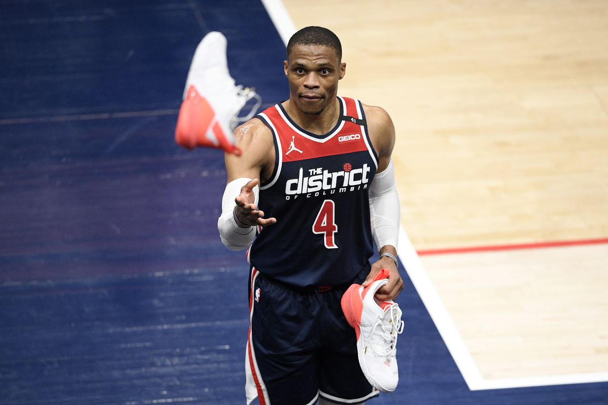 Washington Wizards guard Russell Westbrook throws his shoe into the stands after the team