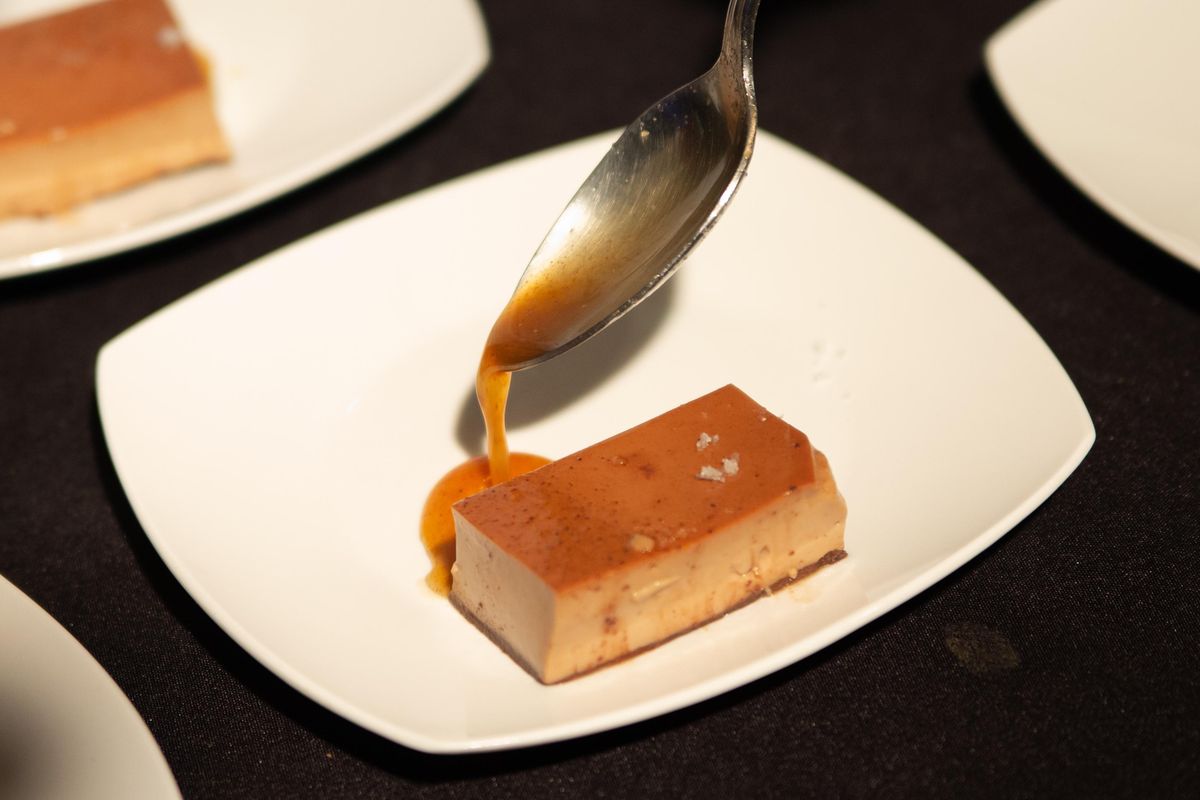 The final course of a special Northwest Passages Book Club event is plated on Dec. 5, 2018, at The Spokesman-Review. It is a chocolate spiced flan with coconut gelato, created by Laurel Randolph and made in an Instant Pot. (Libby Kamrowski / The Spokesman-Review)