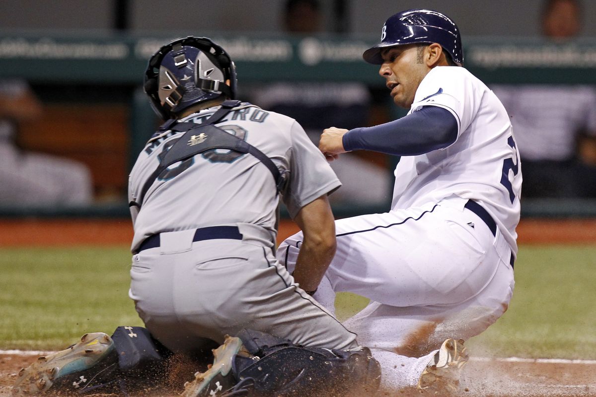 Rays’ Carlos Pena safely slides home. (Associated Press)