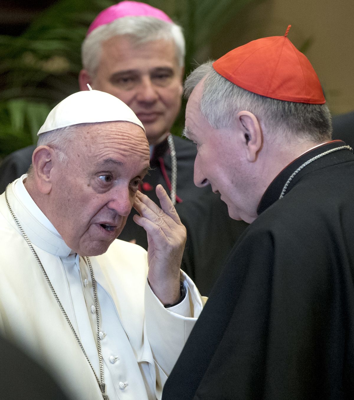 FILE - In this Dec. 21, 2017 file photo, Pope Francis talks to Vatican Secretary of State, Cardinal Pietro Parolin, on the occasion of his Christmas greetings to the Roman Curia in the Clementine Hall at the Vatican. Pope Francis summoned the secretary of state, Cardinal Pietro Parolin, his deputy as well as the Vatican’s top finance official, for a meeting Wednesday, Nov. 4, 2020, and gave the Vatican secretariat of state three months to transfer all its financial holdings to another Vatican office following its bungled management of hundreds of millions of euros in donations and other assets that are now the subject of a corruption investigation.  (Claudio Peri)