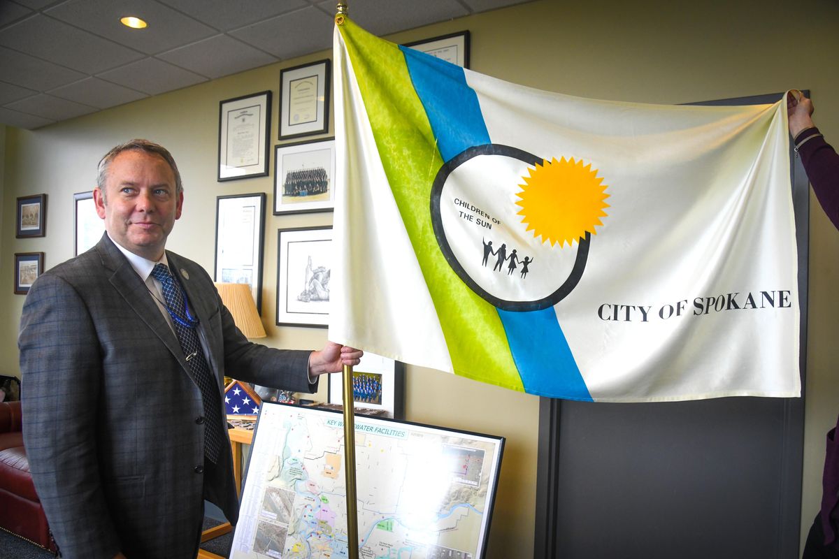 Spokane Mayor David Condon displays the city of Spokane flag in his office, Tuesday, May 21, 2019. (Dan Pelle / The Spokesman-Review)