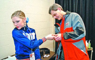 
Dr. Ed Reisman examines skater Brianne Oswald's cut finger Tuesday at the Spokane Convention Center during the U.S. Figure Skating Championships. 
 (Photos by Dan Pelle / The Spokesman-Review)