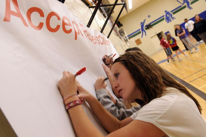 Centennial Middle School eighth grader Darby Howat accepts Rachel’s Challenge after the all-school assembly on Wednesday. (J. Bart Rayniak)