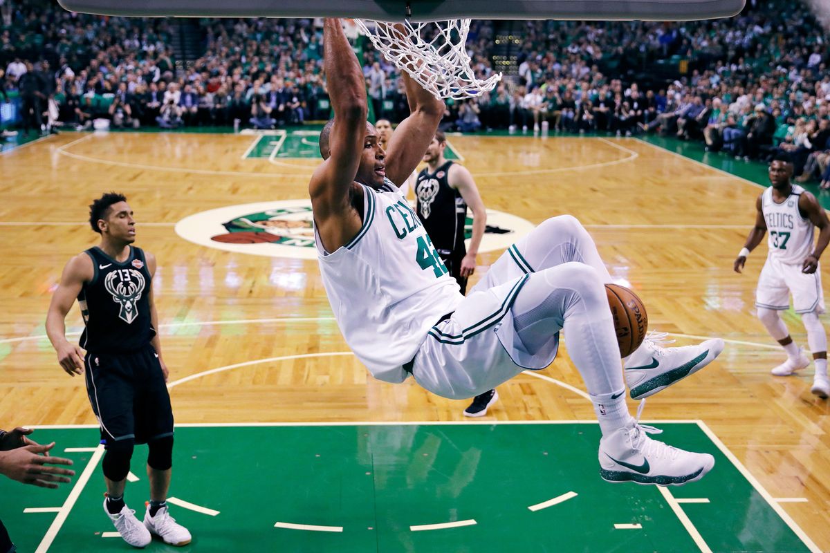 Boston Celtics forward Al Horford hangs from the rim after dunking against the Milwaukee Bucks during the first quarter of Game 5 of an NBA basketball first-round playoff series in Boston, Tuesday, April 24, 2018. (Charles Krupa / Associated Press)