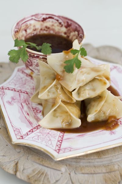 Vegetarian steamed dumplings, shown here with sweet-and-sour sauce, are a traditional food for the Chinese New Yew Year. (Associated Press)