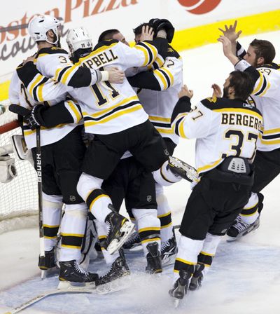 Boston Bruins celebrate after defeating the Vancouver Canucks 4-0 in Game 7 of the NHL  Stanley Cup finals on Wednesday, June 15, 2011, in Vancouver, British Columbia. (Ryan Remiorz / The Canadian Press)