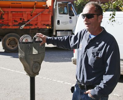 In this Wednesday, Oct. 11, 2017 photo, Wade Beal, parking meter technician, answers a question during an interview in Oklahoma City. The city where parking meters were born says it’s doing away with the last of its ancient, coin-operated models by the end of the year to make way for newer ones. (Sue Ogrocki / Associated Press)