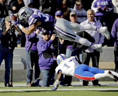 In this Nov. 26, 2016, file photo, Kansas State running back Alex Barnes (34) dives into the end zone over Kansas linebacker Mike Lee (11) to score a touchdown during the first half of an NCAA college football game, in Manhattan, Kan. After beginning last season buried on the depth chart, Barnes wound up rushing for 442 yards and six touchdowns on just 56 carries. That was good enough for second in school history in both categories by a freshman running back. (Charlie Riedel / Associated Press)