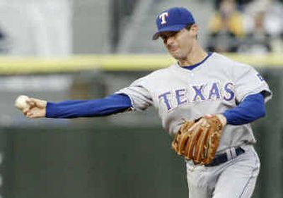 Michael Young has adapted nicely to playing shortstop after previously making himself one of the league's premier second basemen.
(Associated Press / The Spokesman-Review)