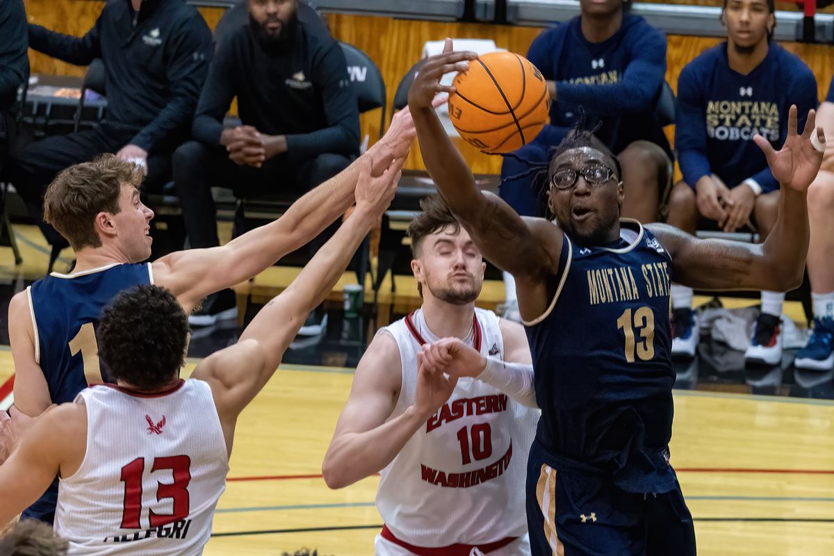Montana State’s Jubrile Belo (13) snares a rebound away from Eastern Washington’s Angelo Allegri, left, and Ethan Price (10) on Monday.  (Colin Mulvany/The Spokesman-Revi)