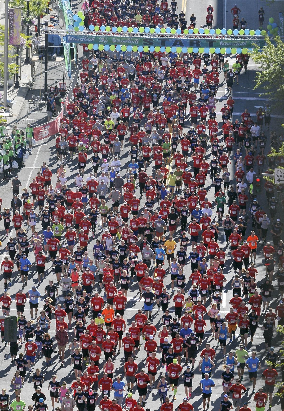 The corportate cup field heads off down Riverside Avenue at the start of Bloomsday 2016, Sunday, May 1, 2016, in Spokane. (Liz Kishimoto / The Spokesman-Review)