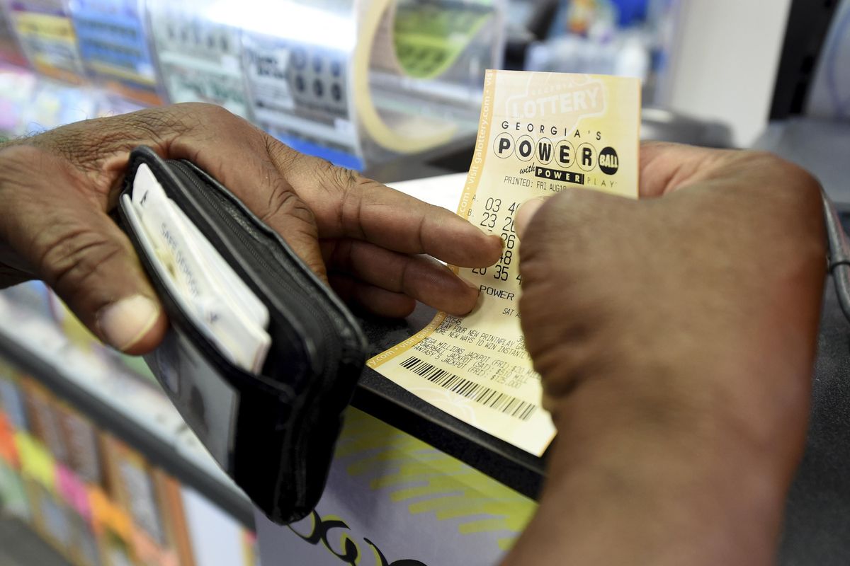 Bowler Samuels holds his Powerball ticket for Saturday’s drawing at Bodie’s convenience store  in Augusta, Ga., Friday afternoon Aug. 18, 2017. (Michael Holahan / Associated Press)