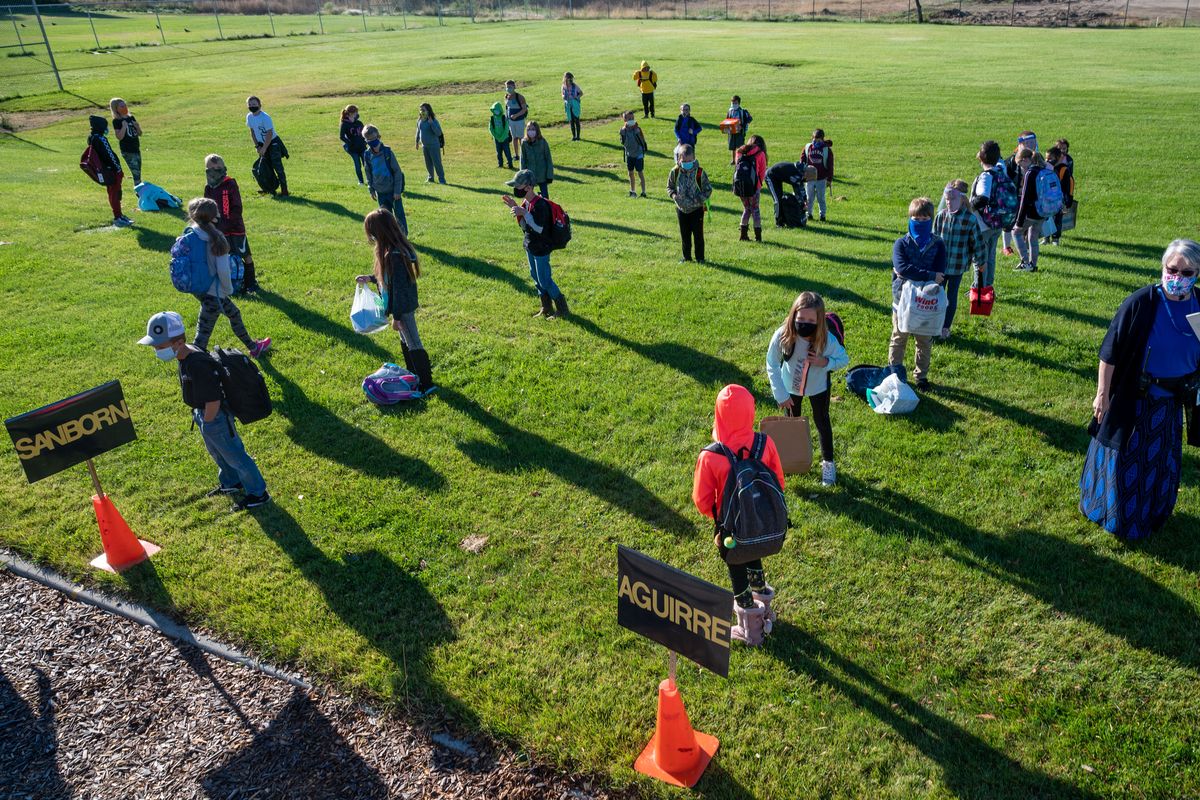 Arcadia Elementary School students, social distance from each other as they line up outside the building on the first day of school, Tuesday, Sept. 8, 2020, in Deer Park, Wash.  (Colin Mulvany/THE SPOKESMAN-REVIEW)