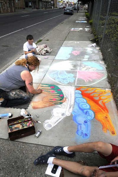 
Sara Van Camp, left center, and Jason Dilon, rear, work on their drawings for the Hillyard ChalkArtWalk 2008 with the theme of 
