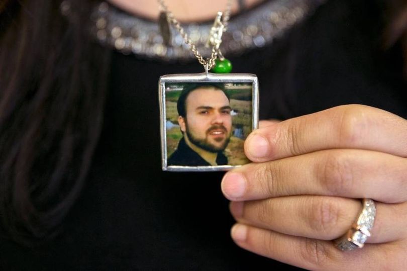 Naghmeh Abedini, holds a necklace with a photograph of her husband, Saeed Abedini, on Capitol Hill June 2, 2015, during a House Foreign Affairs Committee hearing with four people whose family members were being held in Iran. (Jacquelyn Martin/AP field photo)