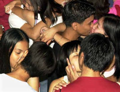 Filipino couples kiss along a Manila bayside boulevard during a pre-Valentine kissing festival that organizers hoped would spur a million couples to lock lips nationwide at the stroke of midnight Saturday. 
 (Associated Press / The Spokesman-Review)