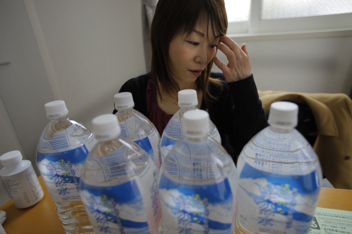 Yoshiko Ota spends $125 a month on bottled water to avoid drinking from the tap. (Associated Press)