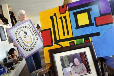 Jean Wood holds a piece of art created by her late husband, Stanley Wood, on display at Area 58, at 3036 N. Monroe St. in Spokane. (Dan Pelle / The Spokesman-Review)