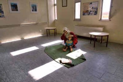 
 An Iraqi mother waits for treatment with her daughter, who is suffering from diarrhea, in the waiting room of the General Teaching Hospital for Children in Baghdad, Iraq, in 2004.
 (File/Associated Press / The Spokesman-Review)