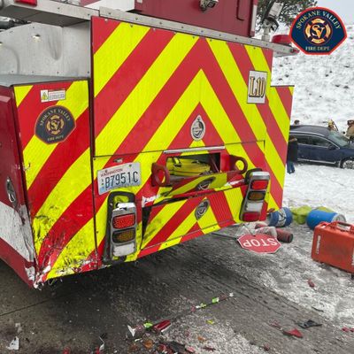 A Spokane Valley Fire Department ladder truck was struck by a vehicle while the truck was assisting a crash Saturday on Interstate 90 near the Sullivan Road exit.  (Courtesy of Spokane Valley Fire Department)