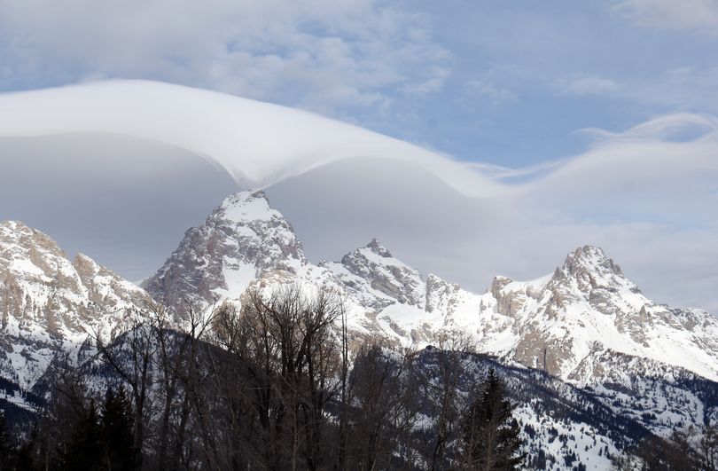 Erupting clouds: An unusual cloud formation across the summit of the Grand Tetons is seen from the park’s headquarters campus at Moose, Wyo., in this Thursday photo provided by the Grand Tetons National Park. (Associated Press)