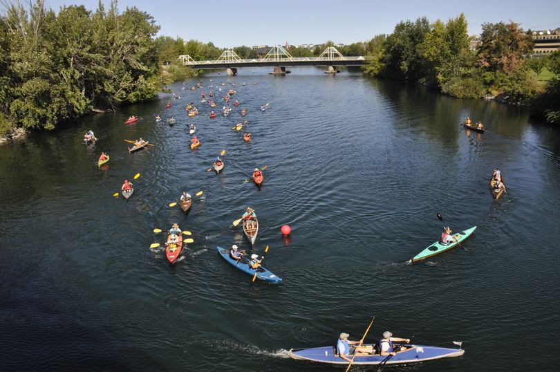 John and Megan Roland led paddlers in the citizen division to the turn-round-buoy after the start of the Spokane River Classic on Aug. 23, 2014. (Rich Landers)