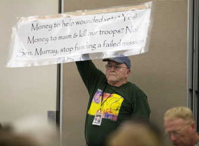 
Joe Colgan, father of Lt. Benjamin Colgan, who was killed in action in Iraq, holds a sign voicing his opinions. Associated Press
 (Associated Press / The Spokesman-Review)